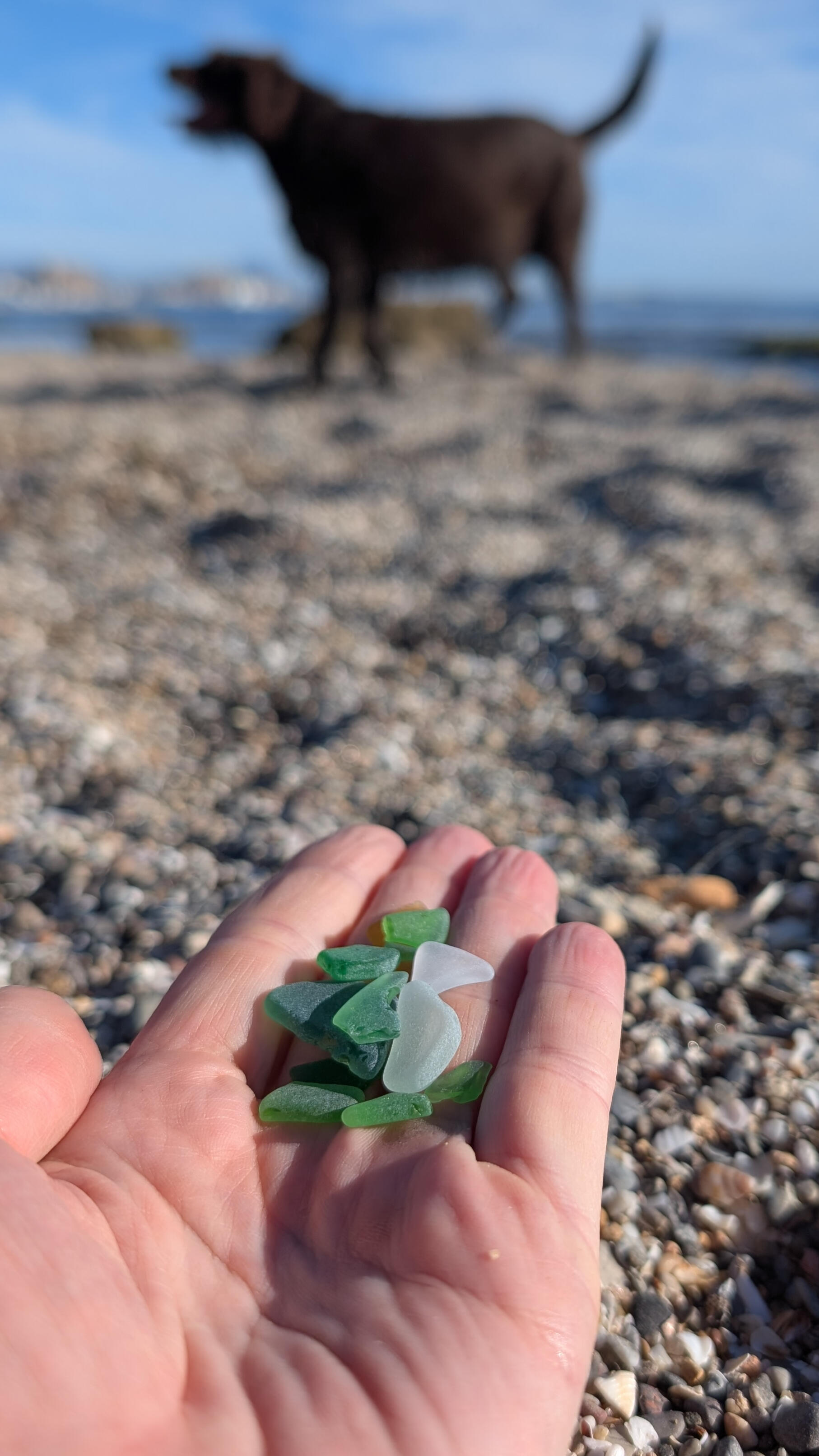 Sea glass held in a hand at the beach